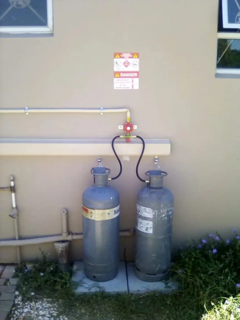 Two gas cylinders connected outside a house
