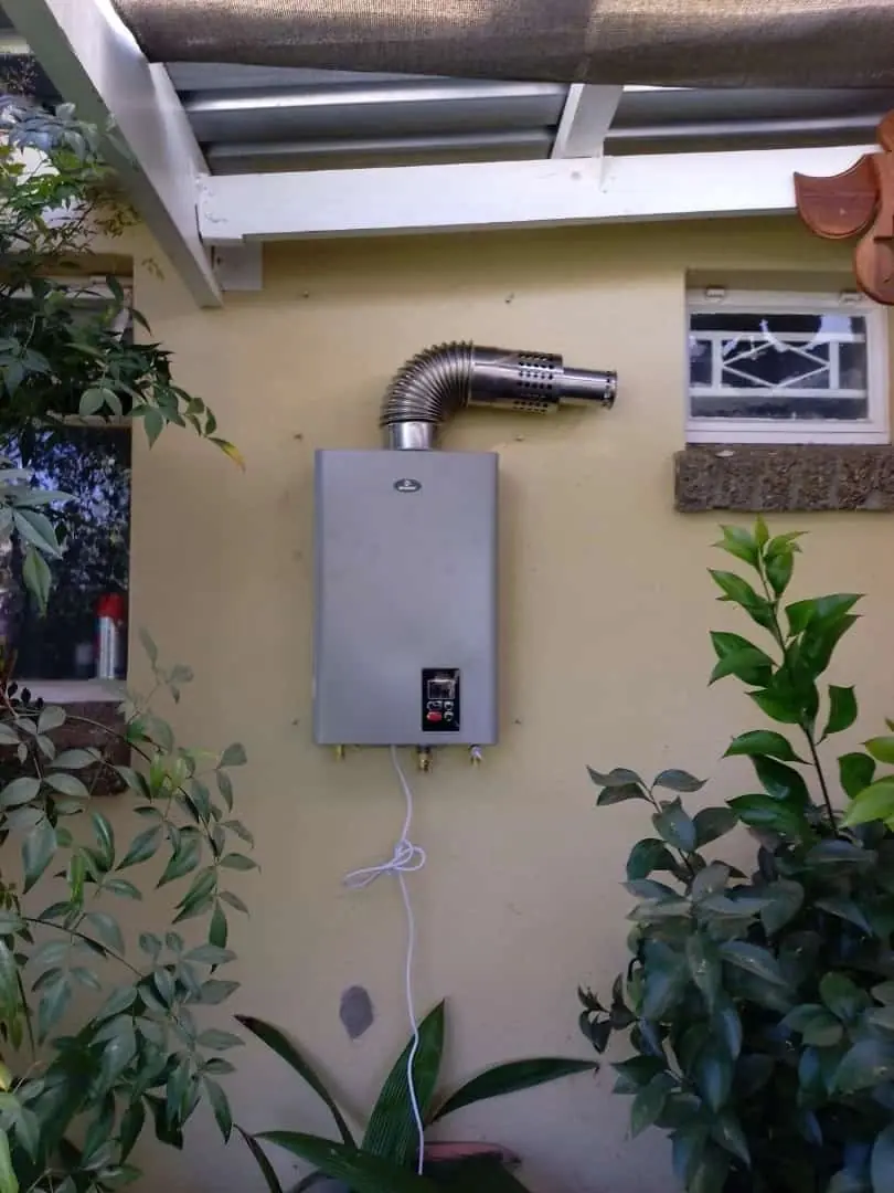 A gas geyser under a covered patio