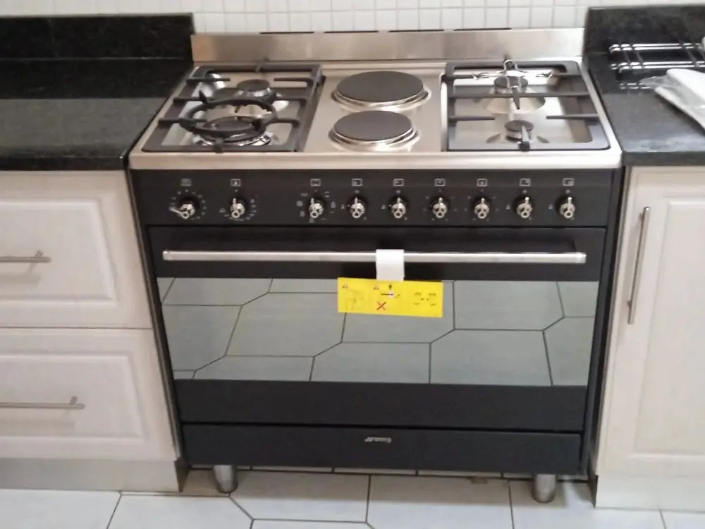 A black Smeg gas stove in a kitchen